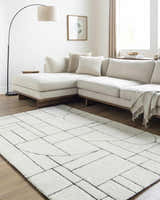 Living room with a cream sectional sofa and Fusao Rose Cream Area Rug featuring a geometric design. Roomscene-Rectangle