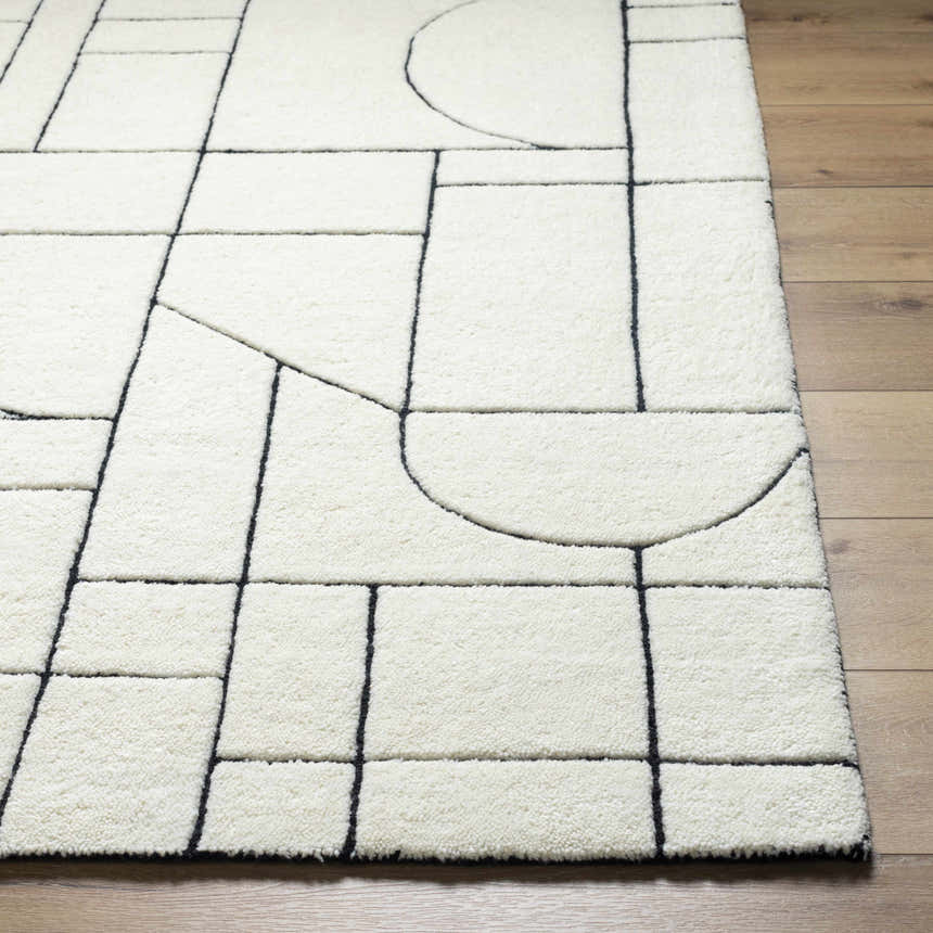 Close up of the Fusao Rose Cream Area Rug showing its beige wool texture and black geometric line pattern. Front