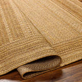 Close-up of a Freja Flatweave Faux Jute Rug in beige and brown, showing the texture and woven pattern. Fold