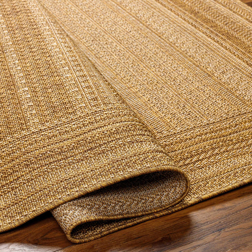 Close-up of a Freja Flatweave Faux Jute Rug in beige and brown, showing the texture and woven pattern. Fold