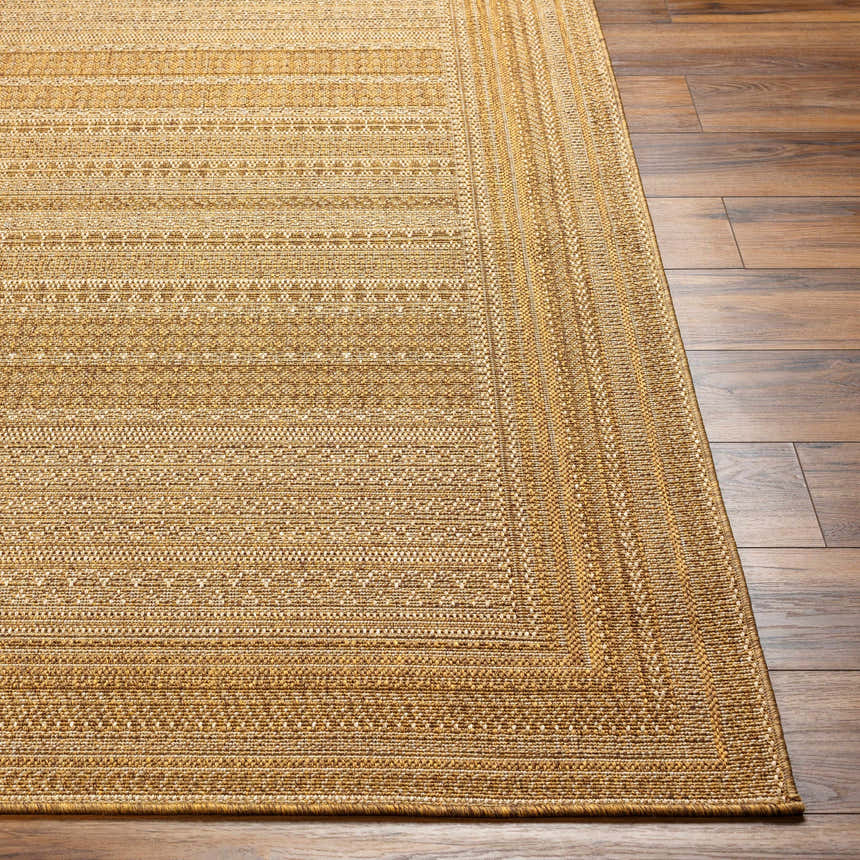 Close-up of the Freja Flatweave Faux Jute Rug showing beige, camel, and brown tones with a subtle geometric pattern. Front