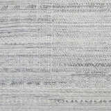 Close-up of the Gray Eldad Area Rug showing its hand-knotted texture and subtle black and metallic silver pattern. Swatch