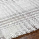 Close-up of the hand-woven Inara Plaid Area Rug. Gray, light gray, and silverton hues create a farmhouse, transitional style. Texture