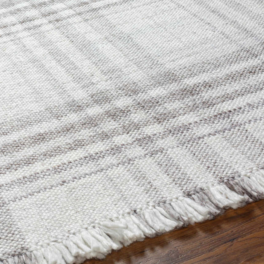 Close-up of the hand-woven Inara Plaid Area Rug. Gray, light gray, and silverton hues create a farmhouse, transitional style. Texture