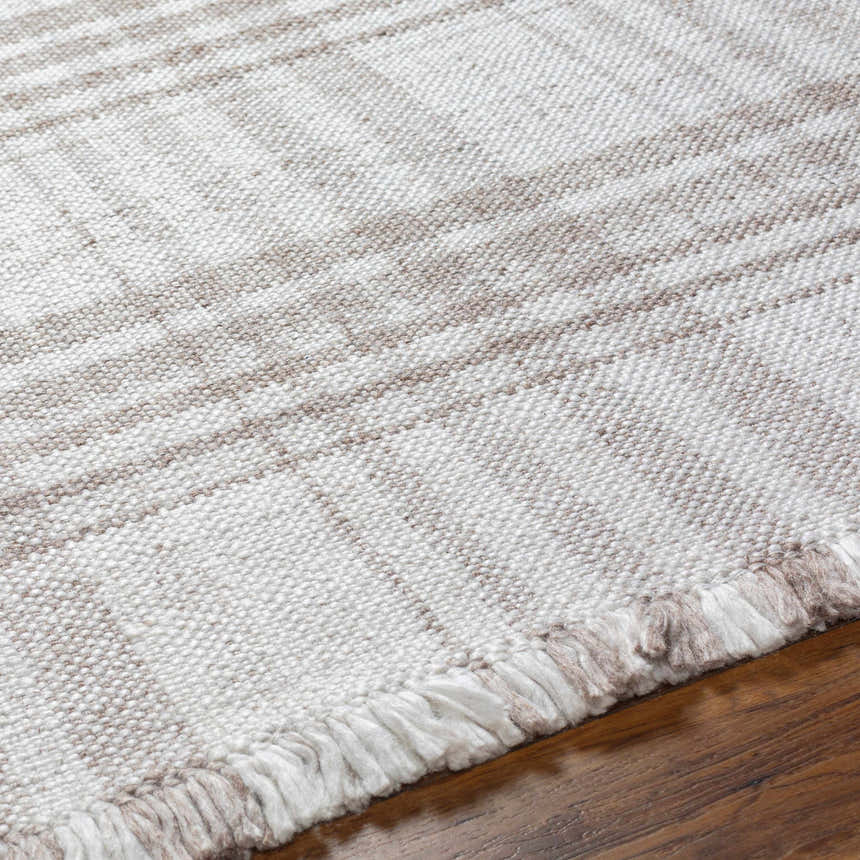 Close-up of the Inara Light Brown Plaid Hand Woven Area Rug showing beige, brown plaid pattern and fringe detail. Texture