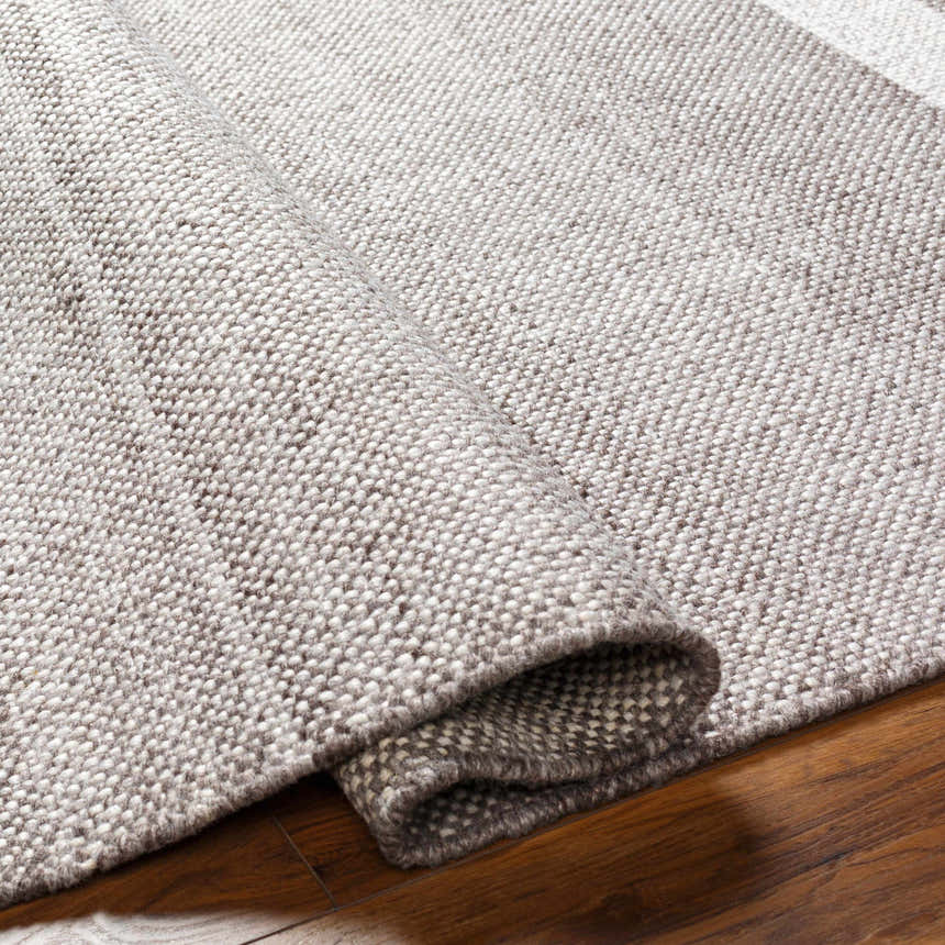 Close up of the hand woven Loic Light Brown Area Rug showing texture and color. Fold