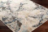 Close-up of the contemporary Gamze Area Rug. Colors include charcoal, beige, brown, gray, and lambswool. Corner