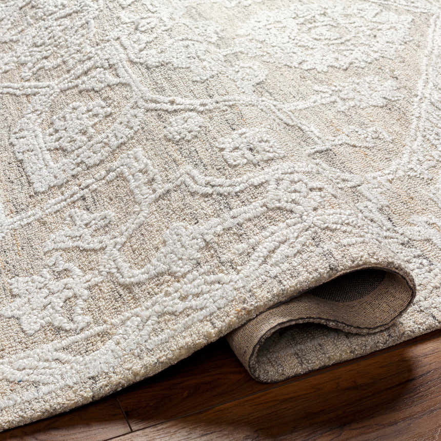 Close up of the hand-tufted White Derya Area Rug showing its farmhouse style pattern and recycled PET yarn texture. Fold
