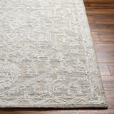 Close up of the White Derya Area Rug showing its traditional gray pattern and hand-tufted texture on wood floors. Front