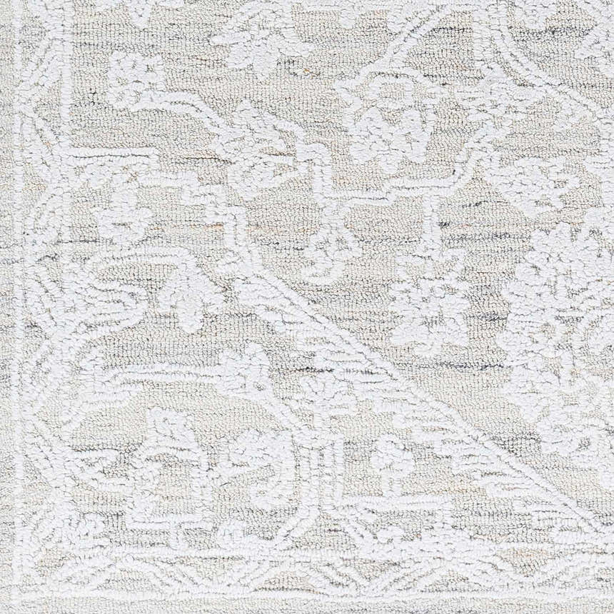 Close-up of the White Derya Area Rug showing its hand-tufted texture and farmhouse-style gray and white traditional pattern. Swatch