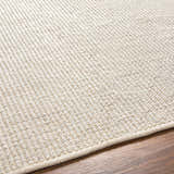 Close up of the hand woven Edith Premium Rug in beige and gray, showing texture. Texture