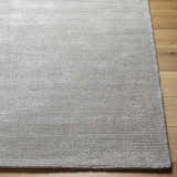 Close up of the silver gray Noham Area Rug showing hand tufted texture and horizontal lines. Front