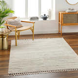 Living room scene with a cream Levy Area Rug, wood floors, chair, and cabinet. Neutral tones create a cozy, contemporary vibe. Roomscene-Rectangle