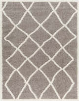 Close-up of the Alkas Area Rug, a gray shag rug with a white geometric diamond pattern. Contemporary style. Design-Rectangle-537