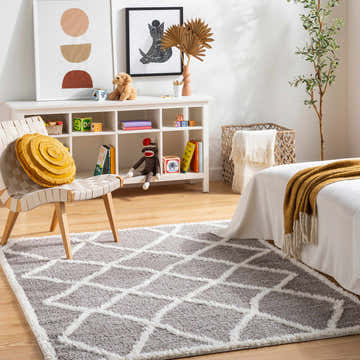 Kids room with geometric Alkas Area Rug in gray and white, styled with a white bed and playful decor. Roomscene-Rectangle