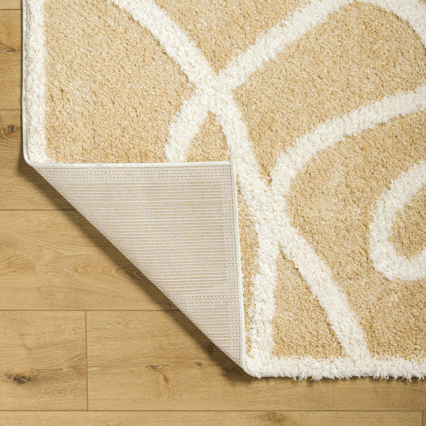 Close-up of the Gilon Camel Plush Area Rug showing its plush texture, geometric pattern, and rug backing. Fold