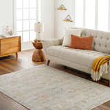 Living room scene with a beige sofa and the neutral-toned, traditional Ayane Area Rug on hardwood floors. Roomscene-Rectangle