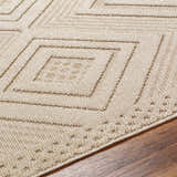 Close-up of the Aimee Lambswool Area Rug showing its geometric diamond pattern and soft, textured weave in camel and light brown. Texture