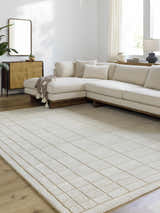 Living room with a neutral sectional sofa and a light gray Sedna Wool Area Rug with a geometric square pattern. Roomscene-Rectangle