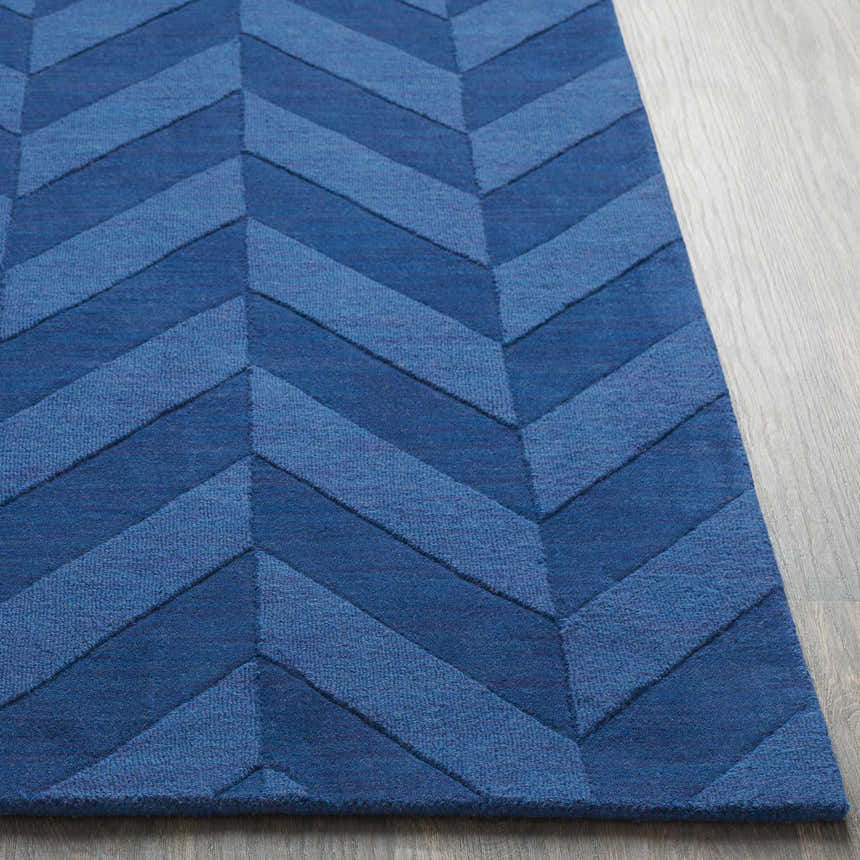 Close-up of the navy Searsmont Area Rug showcasing its chevron pattern and textured weave. Front