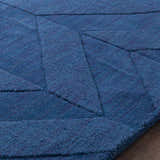Close up of the navy Searsmont Area Rug, featuring a geometric pattern and soft, textured pile. Texture