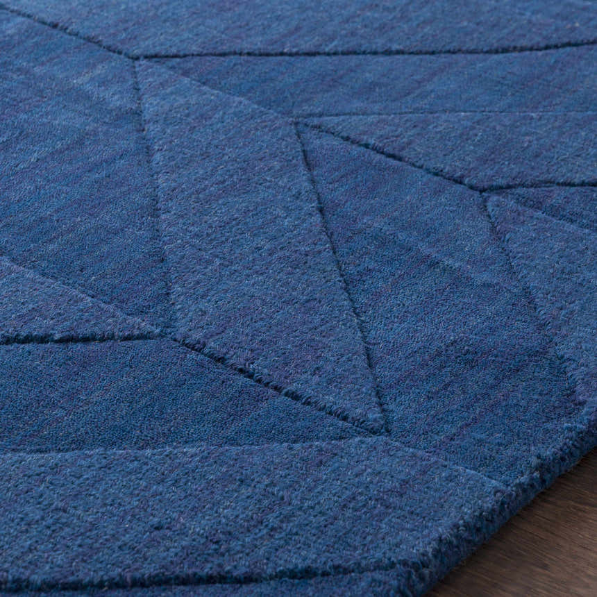 Close up of the navy Searsmont Area Rug, featuring a geometric pattern and soft, textured pile. Texture