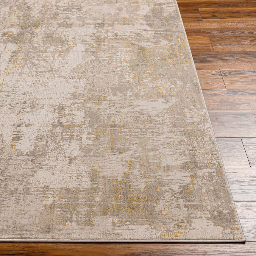 Close-up of Rama Cream Area Rug showing abstract beachhouse, gray, and nutmeg pattern on hardwood floor. Front