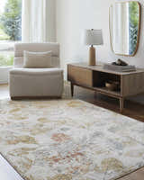 Living room scene with a neutral chair and the Ouida Floral Rug in copper, silver, and natural tones. Roomscene-Rectangle