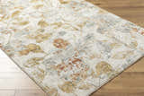 Close-up of the Ouida Floral Rug. Copper, light silver, and natural tones create a farmhouse-style floral pattern. Corner