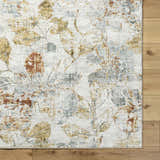 Close-up of the Ouida Floral Rug. Copper, silver, and natural tones create a farmhouse-style floral pattern. Corner