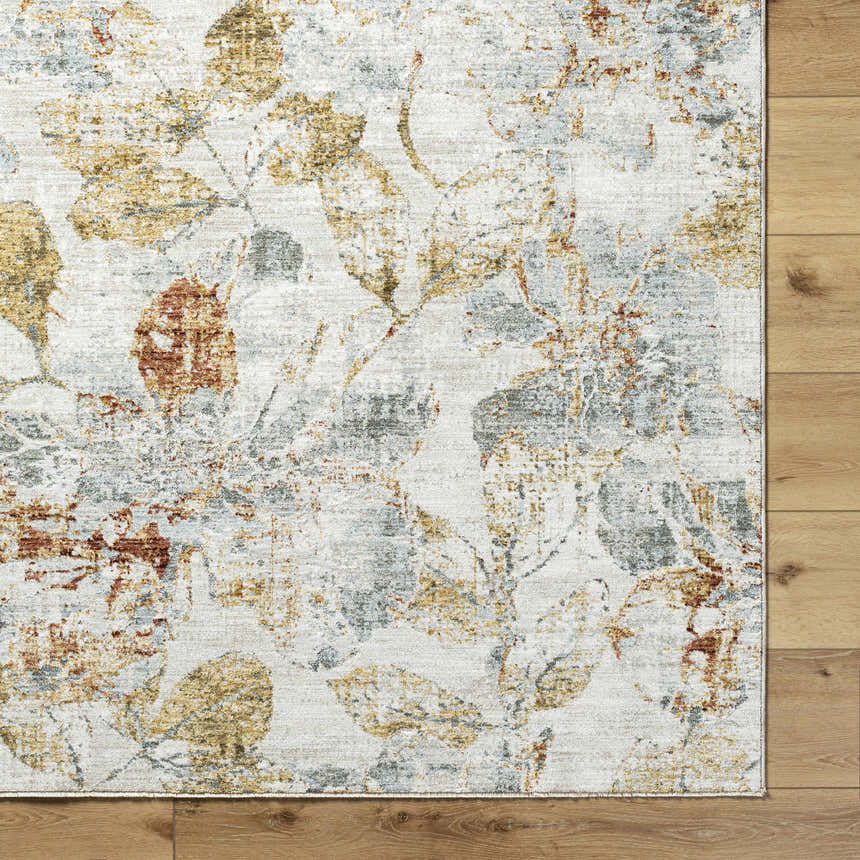 Close-up of the Ouida Floral Rug. Copper, silver, and natural tones create a farmhouse-style floral pattern. Corner