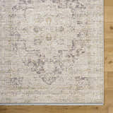 Close-up of the beige Njeri Area Rug showing its traditional farmhouse pattern and polyester texture on wood floors. Corner