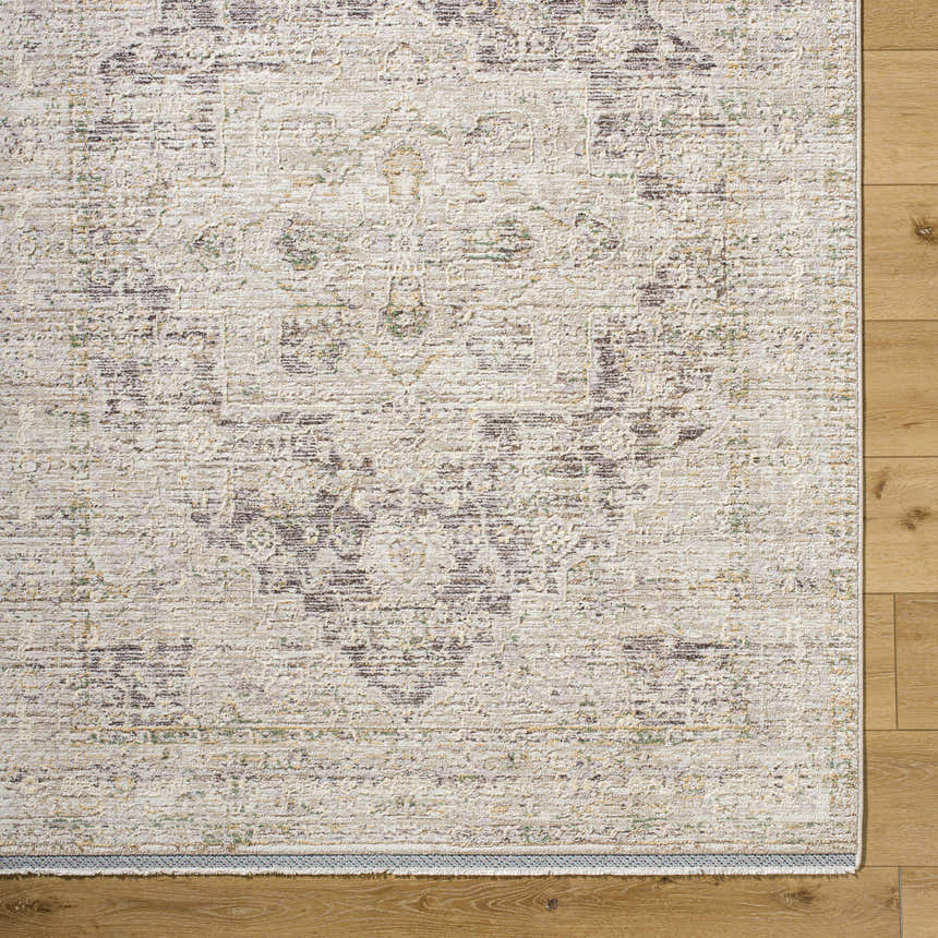 Close-up of the beige Njeri Area Rug showing its traditional farmhouse pattern and polyester texture on wood floors. Corner