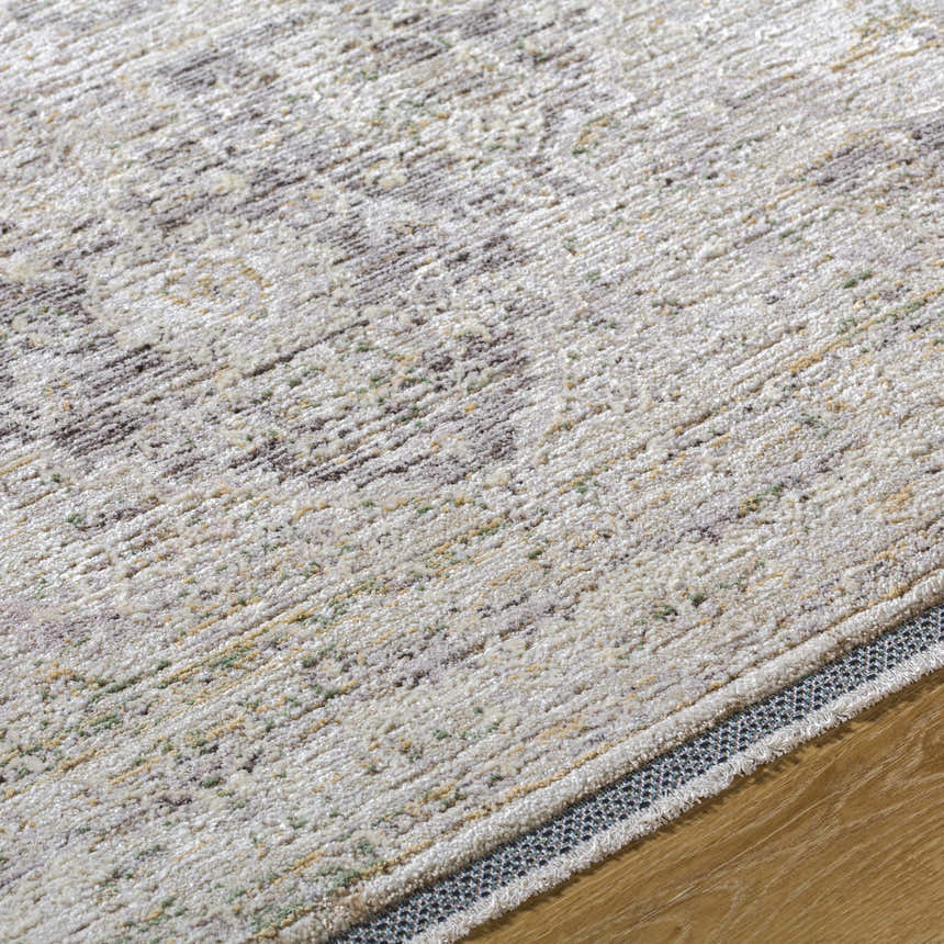 Close-up of the Beachhouse beige Njeri Area Rug showing its traditional pattern and soft, textured weave. Texture