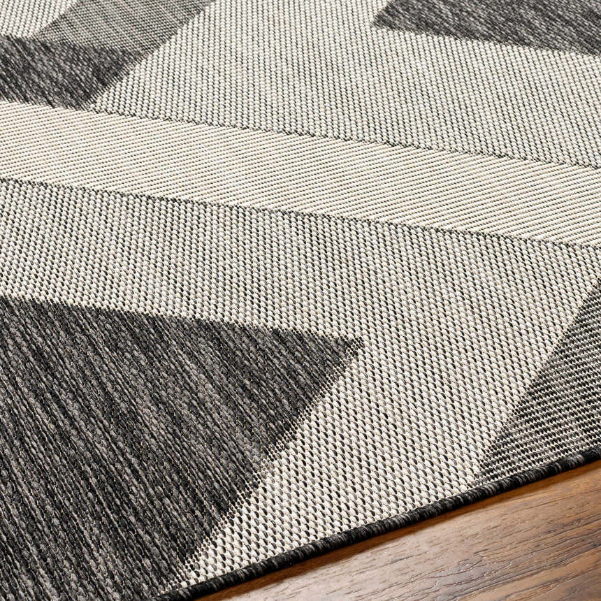 Close up of the Adwen Gray Area Rug showing geometric pattern and woven texture. Texture