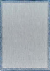 Close-up of the Aleid Blue Area Rug, showcasing its woven texture, denim blue border, and geometric pattern. Design-Rectangle-537