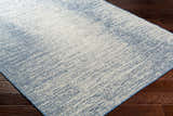 Close-up of Medi Silver Blue Area Rug showing its contemporary beige and blue abstract pattern and woven texture. Corner
