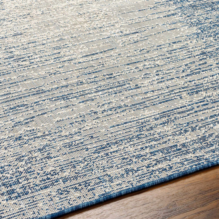 Close-up of the Medi Silver Blue Area Rug showing its woven texture and subtle blue and beige pattern. Texture