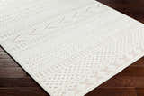 Close-up of the cream Jove Outdoor Rug showing its southwestern-inspired, textured geometric pattern. Corner