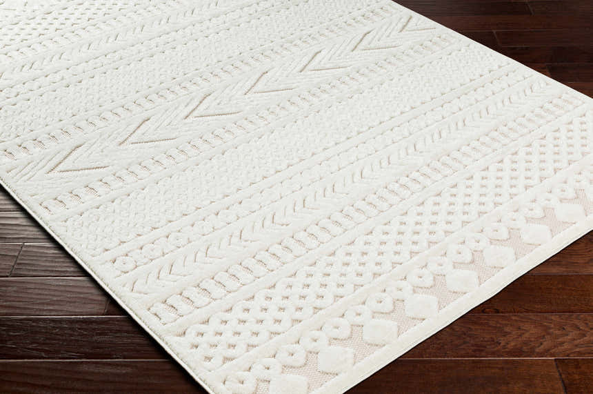 Close-up of the cream Jove Outdoor Rug showing its southwestern-inspired, textured geometric pattern. Corner