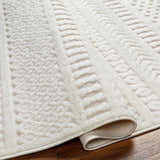Close up of the cream Jove Outdoor Rug showing its southwestern textured pattern and soft pile. Fold