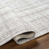 Close-up of the hand woven Jezel Beige Area Rug showing its neutral color palette and subtle pattern. Fold