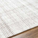 Close-up of the hand woven Jezel Beige Area Rug showing texture and subtle farmhouse style pattern. Texture
