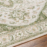 Close-up of Gauri Green Medallion Area Rug showing farmhouse style, floral pattern, and soft texture on wood floor. Texture