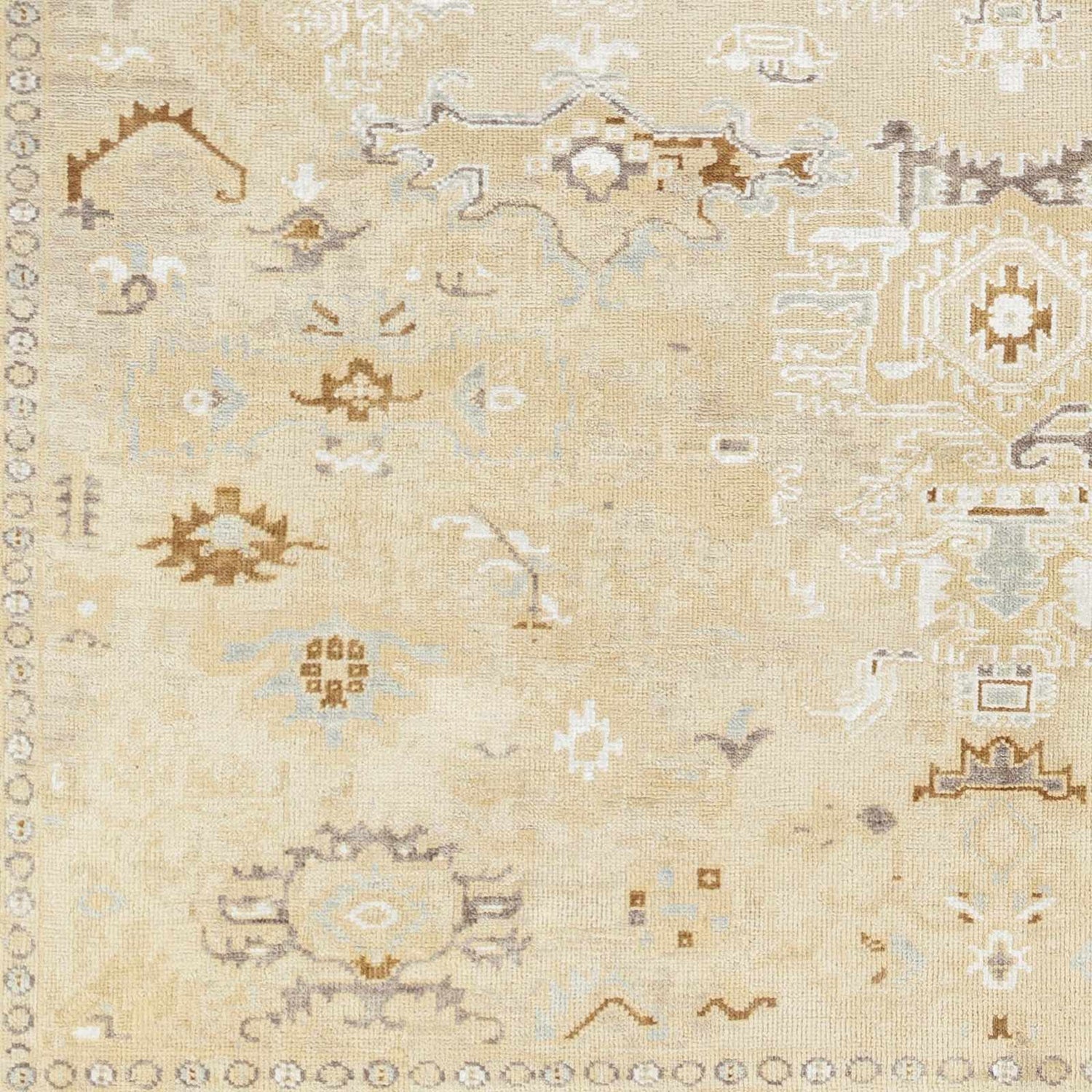 Close up of the hand-knotted Danyl Area Rug. Traditional, vintage design in taupe, white, and brown wool. Swatch