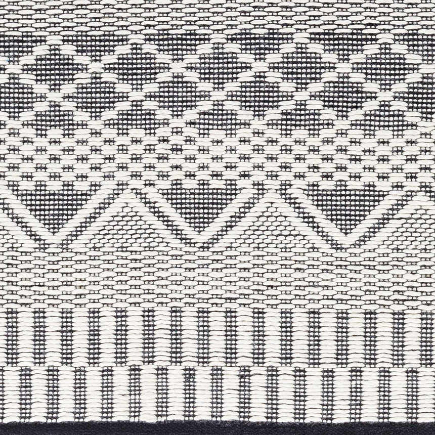 Close-up of the hand woven Carly Area Rug, featuring a geometric pattern in dark gray, nickel, off white, smoke, and taupe. Swatch