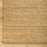 Close-up of Doris Beige Area Rug showing hand-woven jute and cotton texture with a neutral gray border on wood floor. Swatch