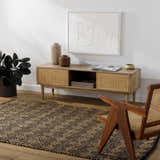 Living room scene with a brown Irina Area Rug, wood console table, chair, and neutral decor. Roomscene-Rectangle