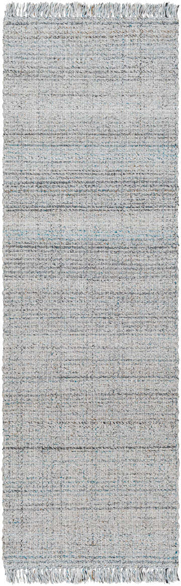 Close-up of the Light Blue Aron Area Rug, a hand-woven rug with a subtle pattern and fringe. Colors include light blue, gray and nutmeg. Design-Runner-268
