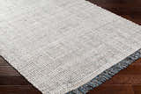 Close-up of the Beige Teal Aron Area Rug showing its woven texture and teal, brown, and charcoal flecks. Corner